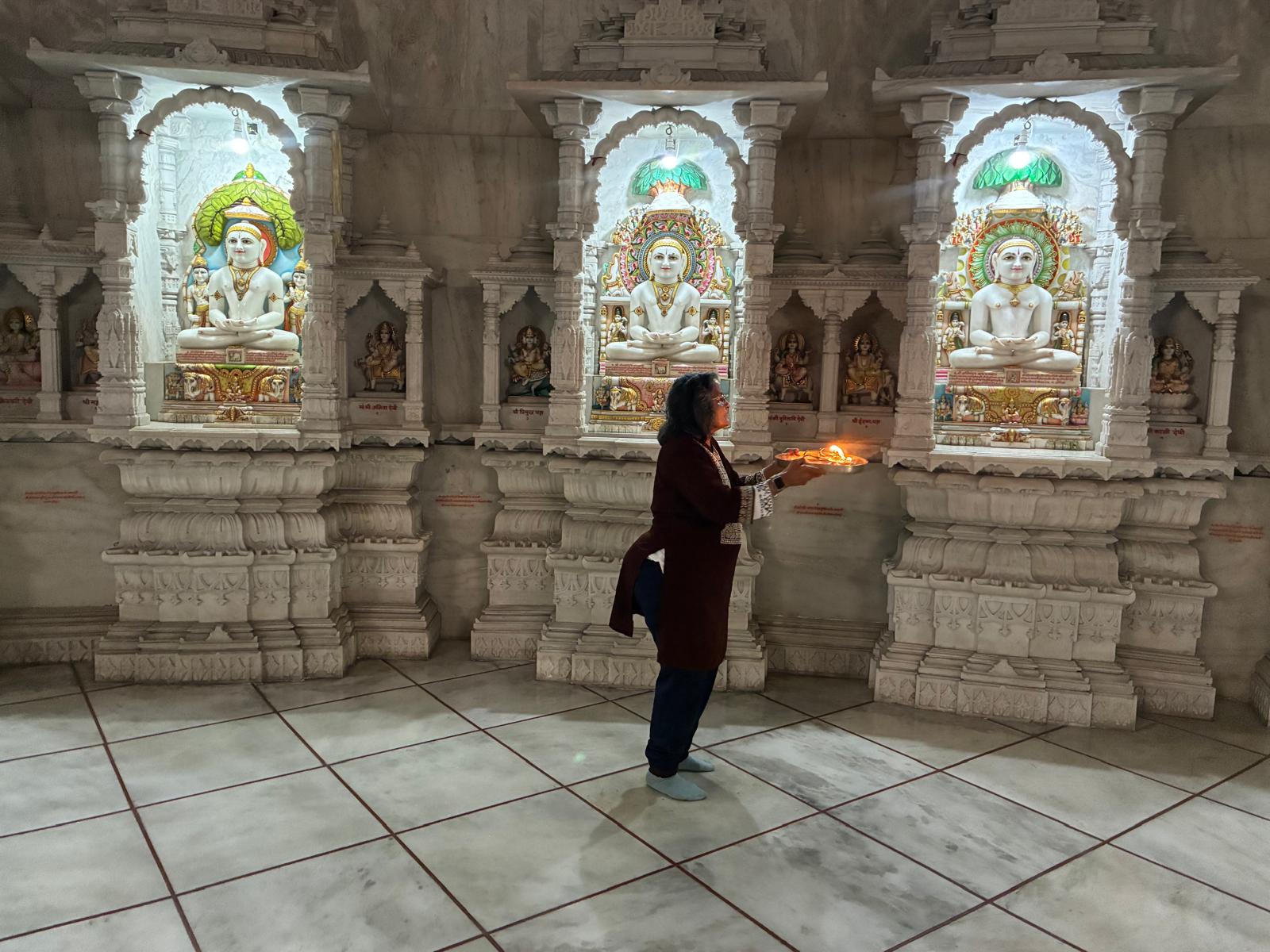 Harsha Patel offering aarti inside a Jain temple